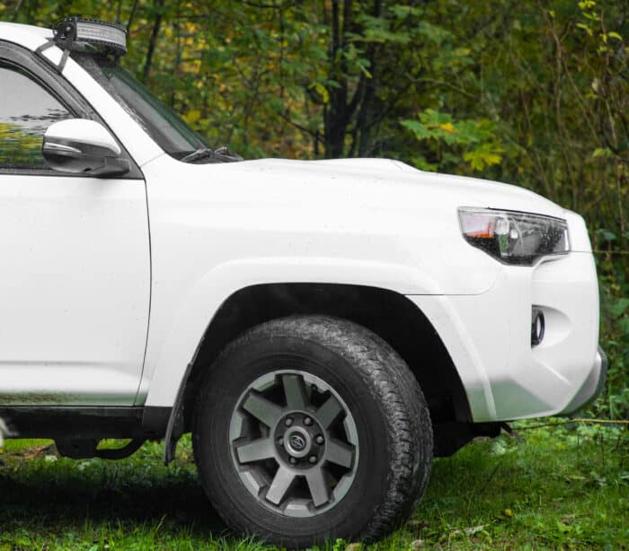 Toyota grand highlander by greenery.