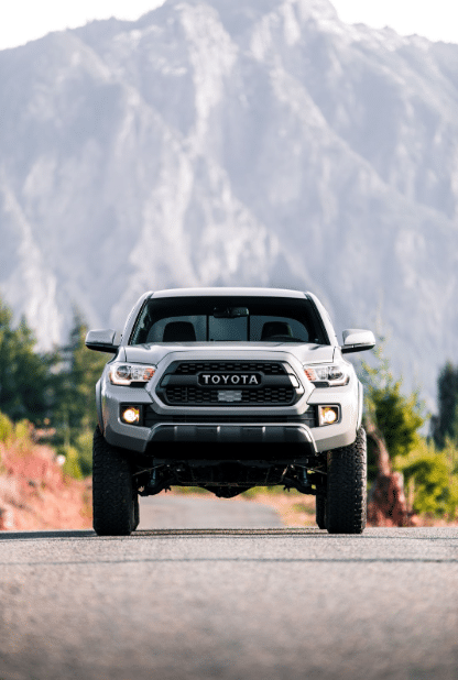 Front-facing shot of the 2024 Toyota Tacoma in front of a mountain.