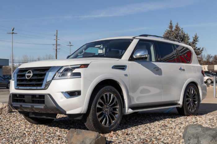 An all white Nissan Armada parked on gravel.