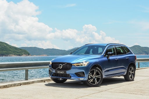 A blue Volvo XC60 parked at a scenic byway.